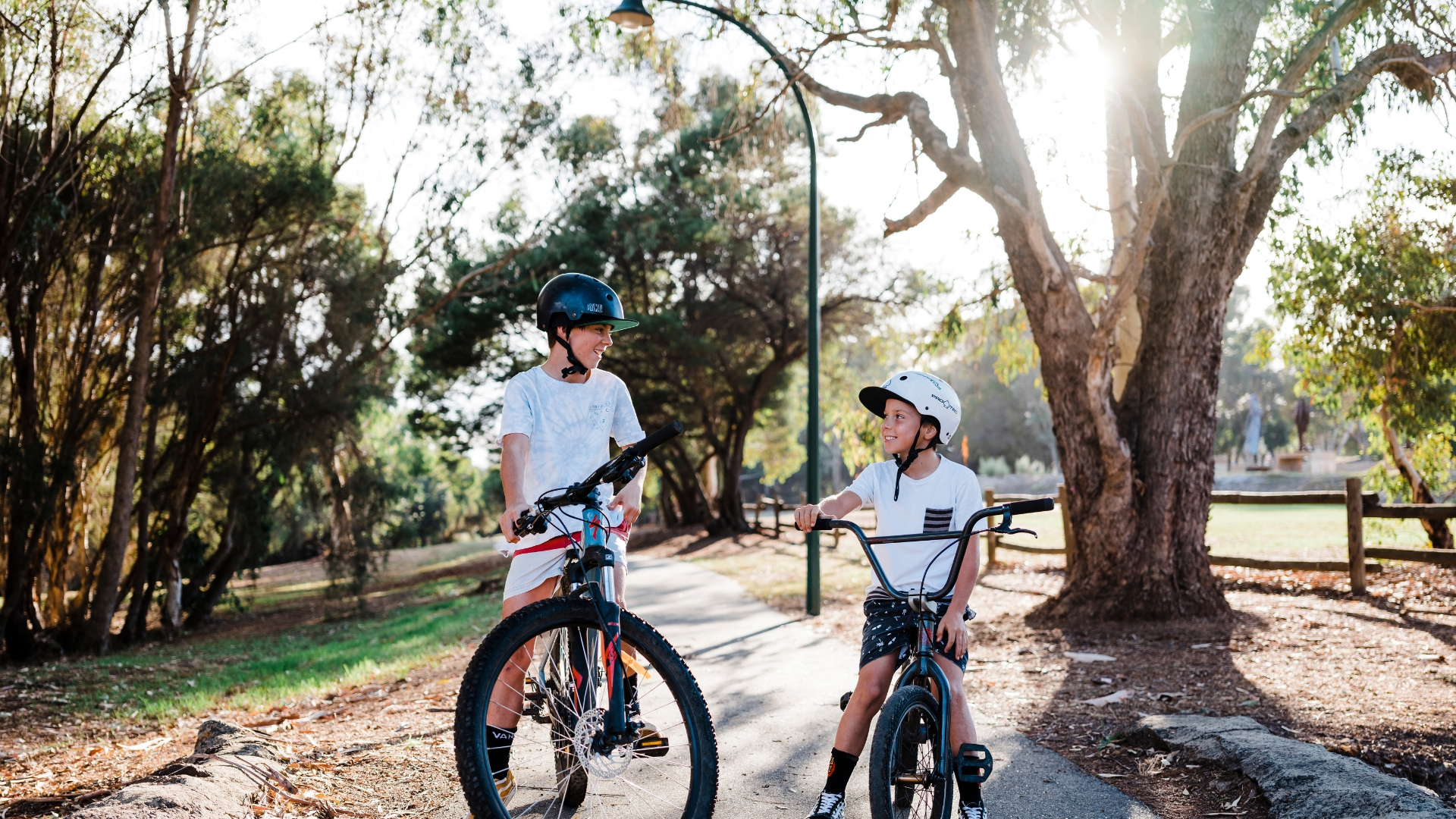 Two children riding their bikes in Hotham Park at Boddington